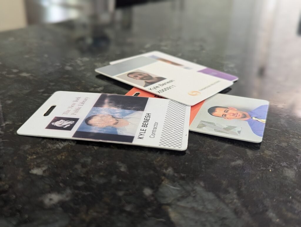 A collection of NYC building access badges from years of field engineering work