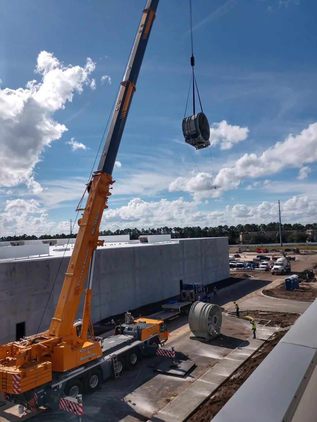 Crane lifting a large fan assembly during a mission-critical emergency fan replacement — Jacksonville, Florida
